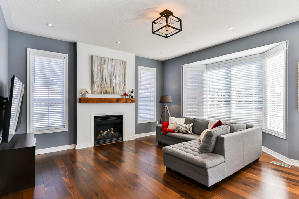 Elegant living room with wood flooring and gray couch