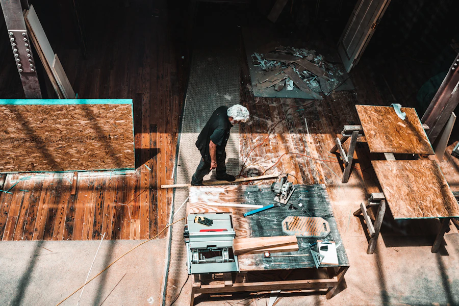 Worker standing near a wooden table during a flooring project