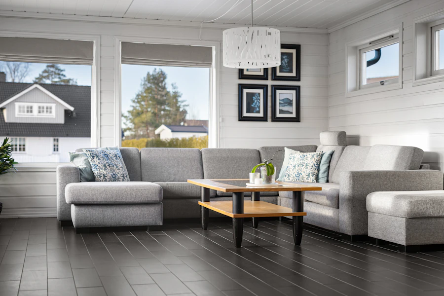 Living room with dark wood flooring and large windows